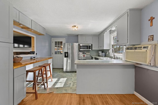 20 Sims Rd, Bristol, CT 06010 - kitchen with stainless steel appliances, a peninsula, a sink, gray cabinets, and light countertops