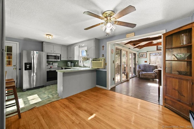 20 Sims Rd, Bristol, CT 06010 - kitchen featuring a sink, open floor plan, stainless steel appliances, light wood-style flooring, and a peninsula