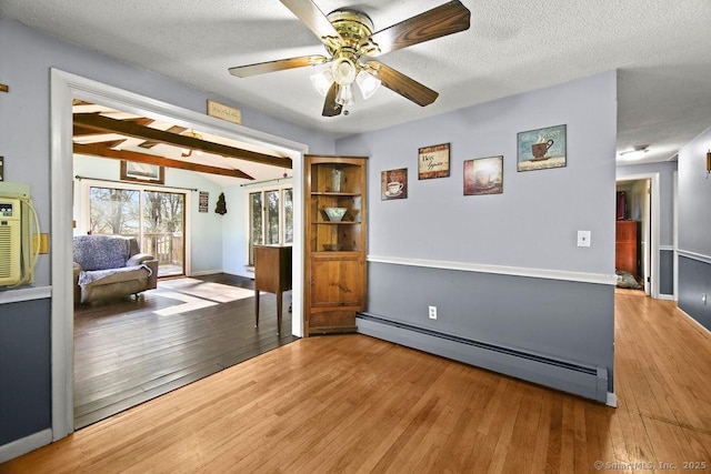 20 Sims Rd, Bristol, CT 06010 - interior space featuring a baseboard heating unit, baseboards, a ceiling fan, and wood finished floors