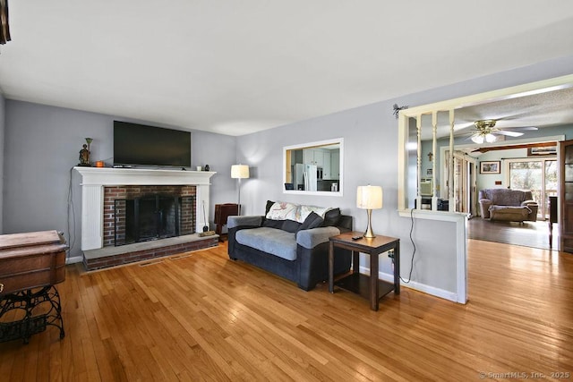 20 Sims Rd, Bristol, CT 06010 - living area with hardwood / wood-style flooring, baseboards, a ceiling fan, and a brick fireplace