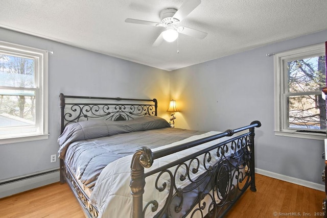 20 Sims Rd, Bristol, CT 06010 - bedroom featuring a ceiling fan, wood finished floors, a textured ceiling, a baseboard heating unit, and baseboards