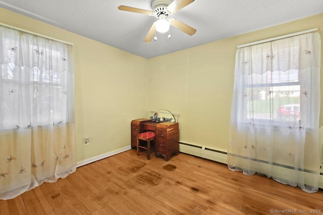 20 Sims Rd, Bristol, CT 06010 - interior space featuring a baseboard heating unit, wood finished floors, a ceiling fan, and baseboards