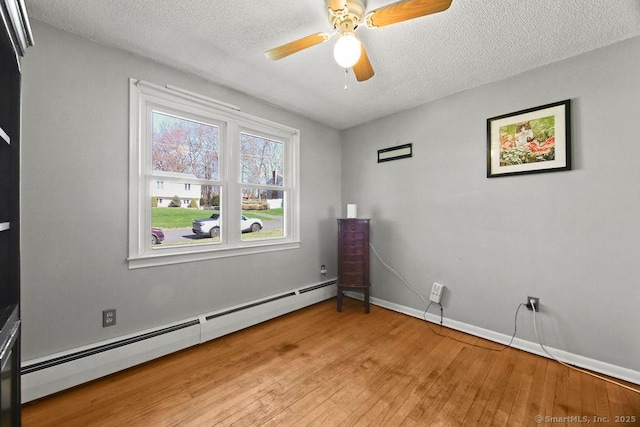 20 Sims Rd, Bristol, CT 06010 - unfurnished room with baseboards, a textured ceiling, light wood finished floors, and baseboard heating