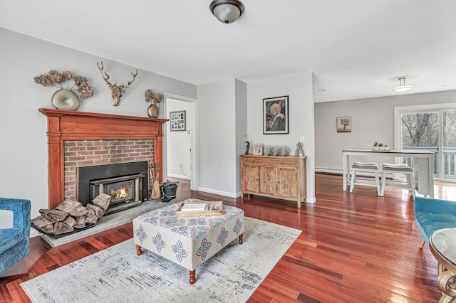 190 Thoreau Dr, Shelton, CT 06484 - living room featuring baseboards, a brick fireplace, and wood finished floors