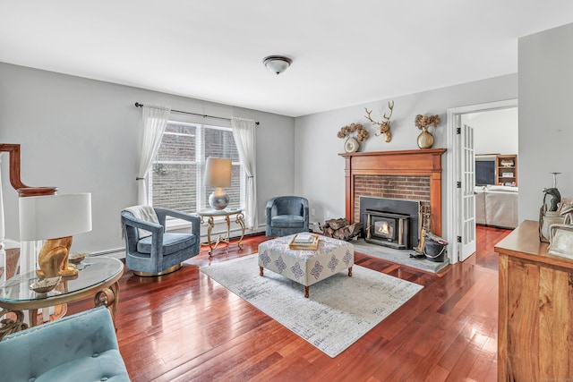 190 Thoreau Dr, Shelton, CT 06484 - living area featuring a baseboard heating unit, hardwood / wood-style flooring, and a brick fireplace