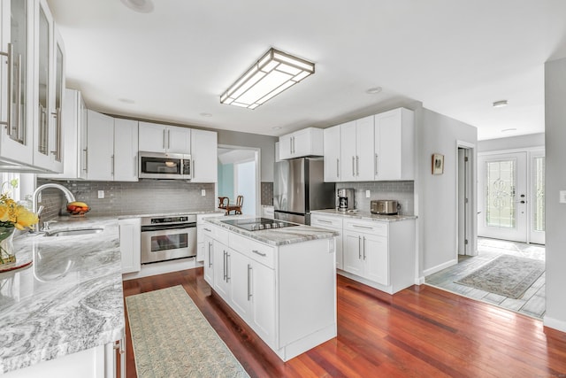 190 Thoreau Dr, Shelton, CT 06484 - kitchen featuring stainless steel appliances, a sink, decorative backsplash, light stone countertops, and dark wood-type flooring