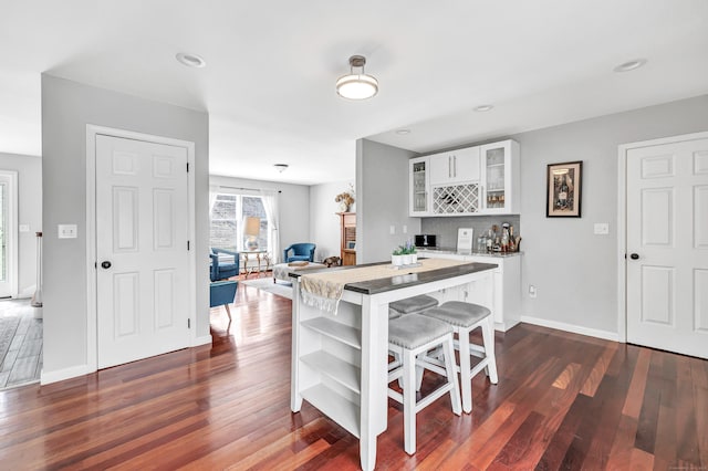 190 Thoreau Dr, Shelton, CT 06484 - dining area with baseboards, a bar, dark wood-style floors, and recessed lighting