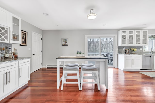 190 Thoreau Dr, Shelton, CT 06484 - kitchen with decorative backsplash, dishwasher, light stone counters, and dark wood-style flooring