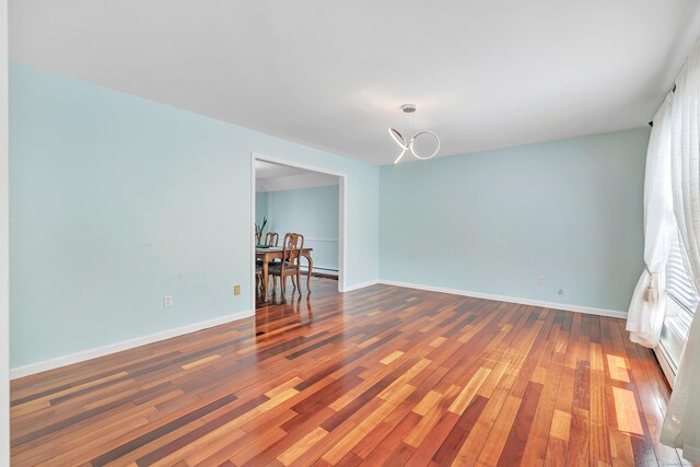 190 Thoreau Dr, Shelton, CT 06484 - unfurnished room with baseboards, wood finished floors, and a chandelier