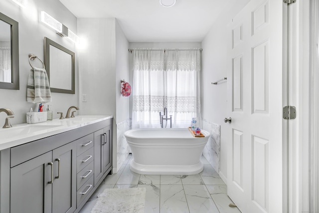 190 Thoreau Dr, Shelton, CT 06484 - full bathroom with a freestanding bath, double vanity, marble finish floor, and a sink