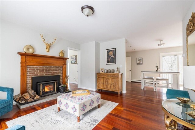 190 Thoreau Dr, Shelton, CT 06484 - living area with wood finished floors, a brick fireplace, and baseboards