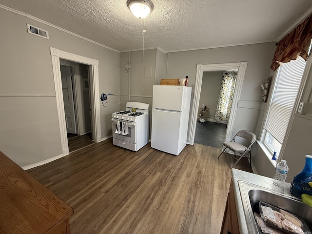 148 Plymouth St, New Haven, CT 06519 - kitchen with dark wood-style floors, crown molding, visible vents, and white appliances