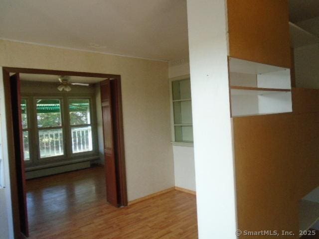 35 Greenhouse Blvd, West Hartford, CT 06110 - corridor with a baseboard heating unit and wood finished floors