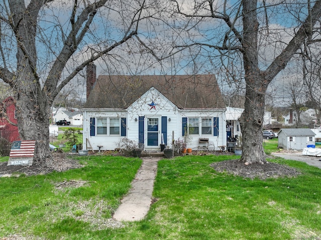 bungalow with a chimney and a front yard