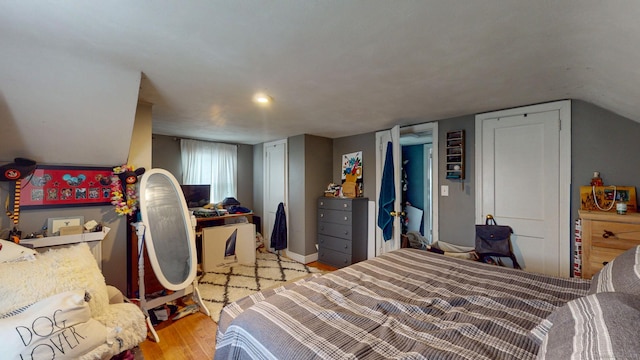 bedroom with wood finished floors and baseboards