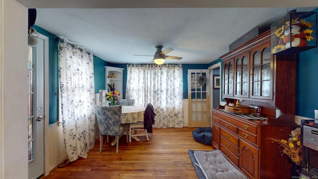 dining area featuring a ceiling fan, wood finished floors, and a healthy amount of sunlight