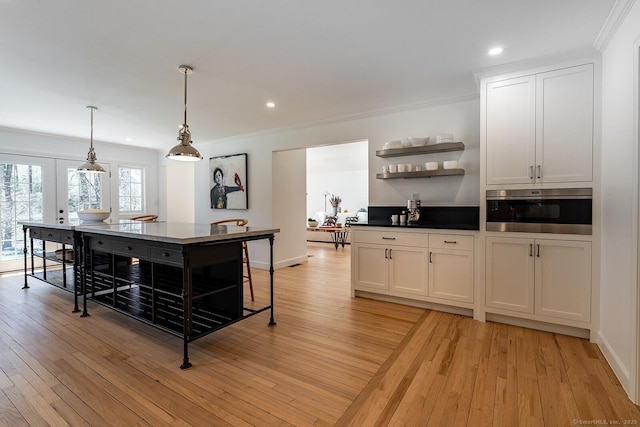 kitchen featuring recessed lighting, open shelves, crown molding, and light wood-style flooring