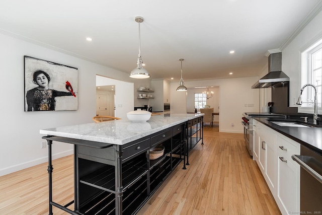 kitchen featuring open shelves, white cabinets, crown molding, a sink, and wall chimney exhaust hood