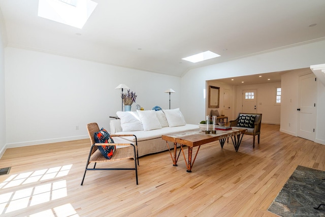 living area with baseboards, visible vents, a skylight, and light wood finished floors