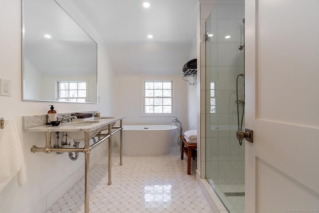 bathroom with a stall shower, lofted ceiling, and plenty of natural light