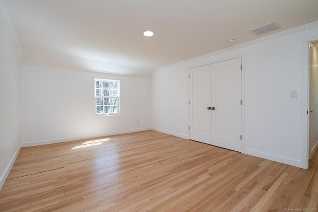 unfurnished bedroom with ornamental molding, visible vents, and light wood-type flooring