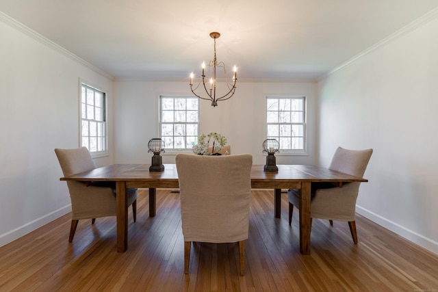 dining room with baseboards, wood finished floors, a chandelier, and plenty of natural light