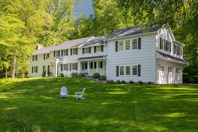 148 W Hills Rd, New Canaan, CT 06840 - view of front of home with a chimney, an attached garage, and a front lawn