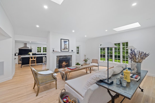 148 W Hills Rd, New Canaan, CT 06840 - living room with a skylight, a fireplace, healthy amount of natural light, light wood finished floors, and recessed lighting