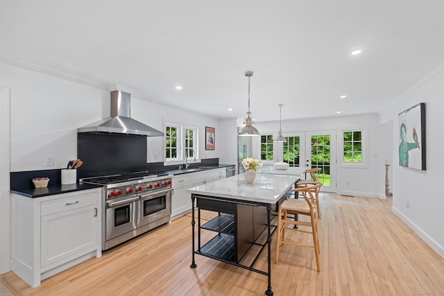 148 W Hills Rd, New Canaan, CT 06840 - kitchen featuring wall chimney exhaust hood, range with two ovens, french doors, a sink, and crown molding