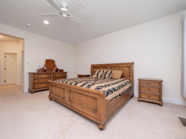 bedroom featuring light colored carpet, recessed lighting, a ceiling fan, and baseboards