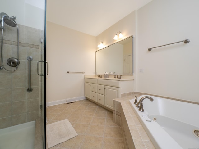 bathroom with a shower stall, a sink, double vanity, a jetted tub, and tile patterned flooring