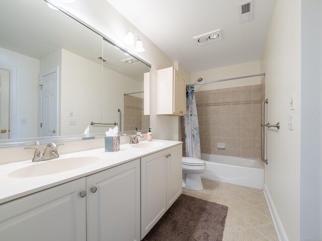 bathroom with tile patterned floors, shower / bath combo with shower curtain, double vanity, and a sink