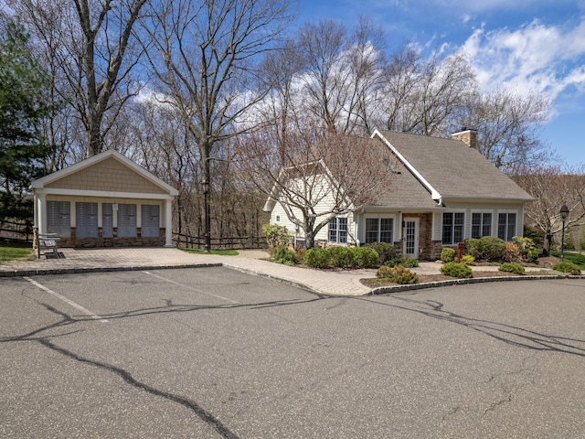 view of front of home with fence and a chimney