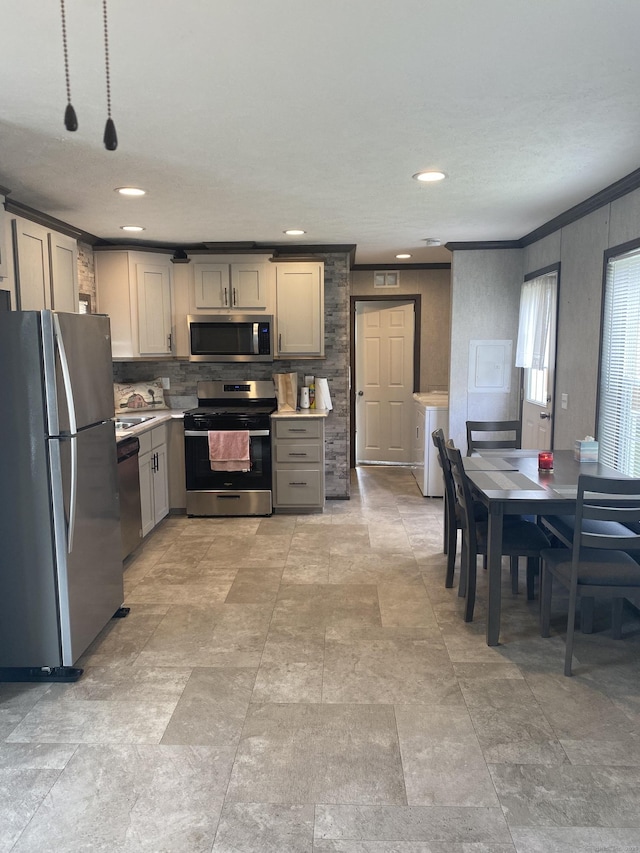 kitchen featuring gray cabinets, separate washer and dryer, appliances with stainless steel finishes, light countertops, and backsplash