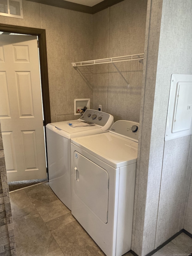 clothes washing area featuring electric panel, independent washer and dryer, laundry area, and visible vents