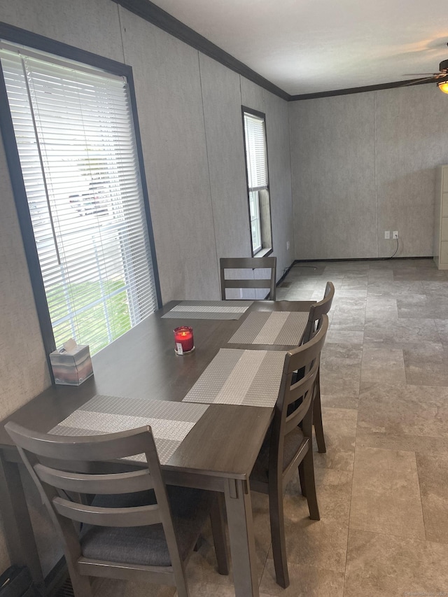 dining space featuring a ceiling fan and crown molding