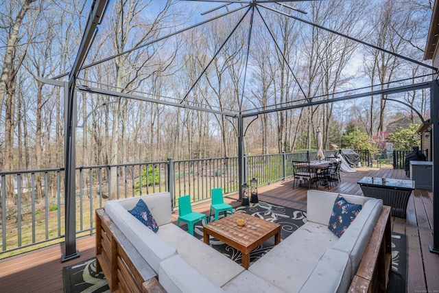 view of patio featuring a wooden deck, outdoor lounge area, and outdoor dining space