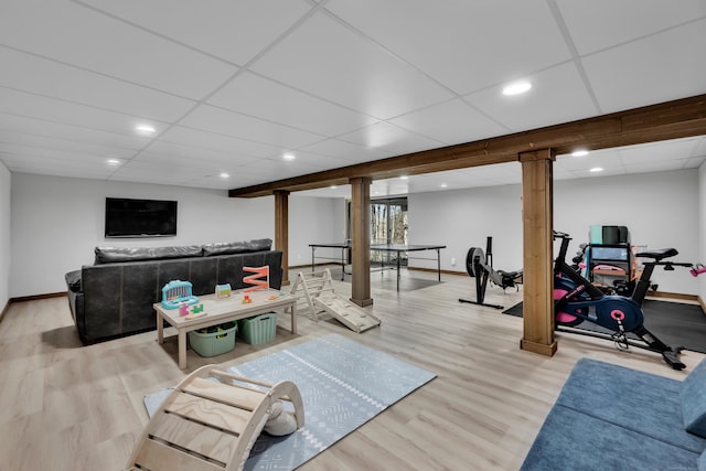 living area featuring recessed lighting, a paneled ceiling, baseboards, and wood finished floors