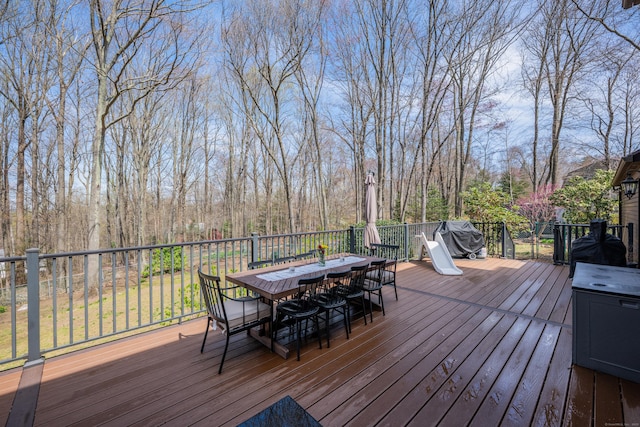 wooden terrace with outdoor dining space