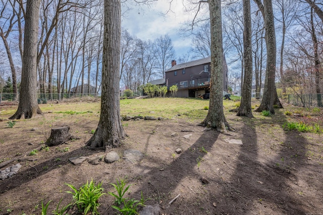 view of yard featuring a wooden deck and fence