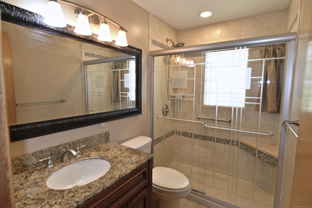full bathroom with a stall shower, toilet, and vanity