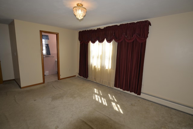 carpeted empty room featuring baseboards and a wealth of natural light