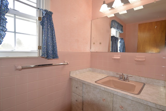bathroom with vanity and tile walls