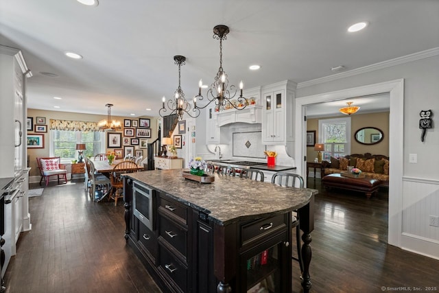 101 N Main St, Essex, CT 06426 - kitchen with an inviting chandelier, stainless steel microwave, a healthy amount of sunlight, and white cabinets