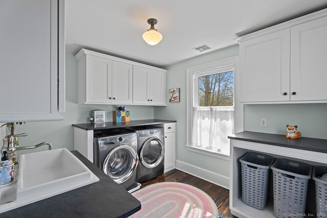 101 N Main St, Essex, CT 06426 - washroom with dark wood-style floors, a sink, cabinet space, washing machine and dryer, and visible vents