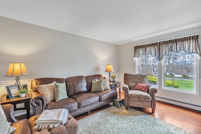 living room with wood finished floors and a baseboard radiator