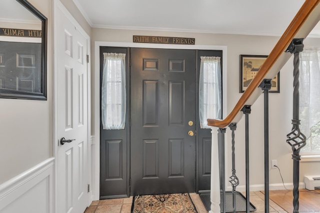 entryway featuring stairs and ornamental molding