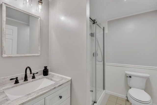 bathroom with vanity, toilet, tile patterned flooring, and a stall shower