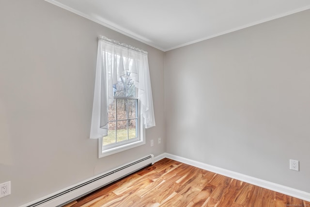 empty room with crown molding, baseboards, light wood-style floors, and a baseboard heating unit
