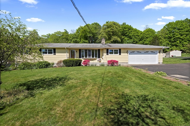 246 Sea Hill Rd, North Branford, CT 06471 - single story home with asphalt driveway, an attached garage, and a front yard